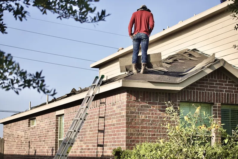 Professional roofer working on a residential roof in Rochelle